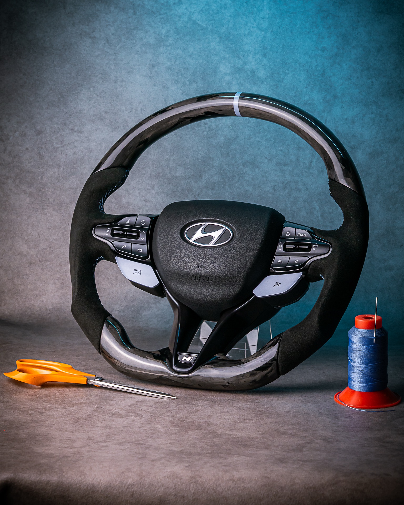 Discover our fully reshaped Hyundai i3ON performance steering wheel-crafted in forged carbon, detailed with baby blue accents, and trimmed in premium Alcantara 9040. A mythic fusion of precision, luxury, and Control Customs UK authority.